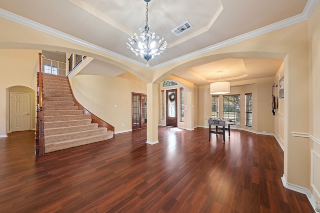 5038 W Fall Dr, Midlothian, TX 76065 - entrance foyer featuring dark wood-type flooring, arched walkways, visible vents, stairs, and a raised ceiling