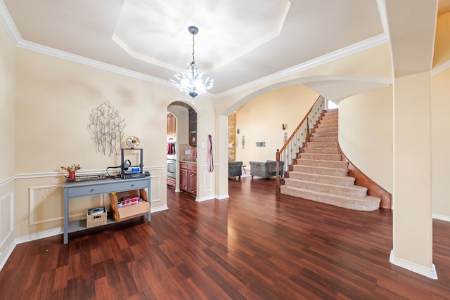 5038 W Fall Dr, Midlothian, TX 76065 - entrance foyer featuring arched walkways, dark wood-style flooring, a decorative wall, a tray ceiling, and stairs