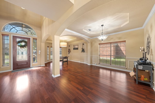 5038 W Fall Dr, Midlothian, TX 76065 - foyer with arched walkways, a notable chandelier, a decorative wall, and wood finished floors