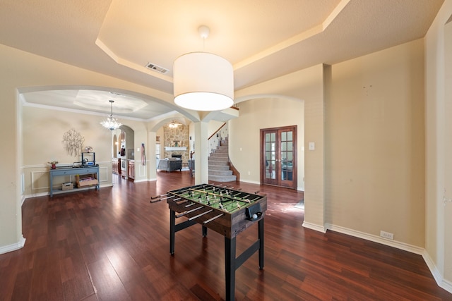 5038 W Fall Dr, Midlothian, TX 76065 - playroom featuring a tray ceiling, wood finished floors, arched walkways, and visible vents