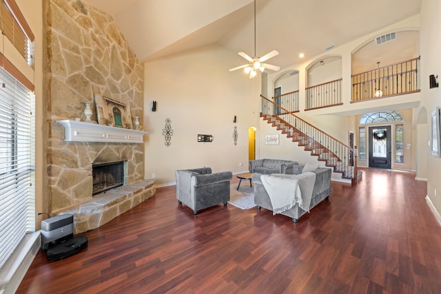 5038 W Fall Dr, Midlothian, TX 76065 - living area with visible vents, ceiling fan, a fireplace, wood finished floors, and stairs