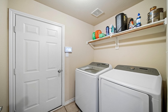 5038 W Fall Dr, Midlothian, TX 76065 - clothes washing area featuring visible vents, laundry area, a textured ceiling, washer and clothes dryer, and light tile patterned flooring