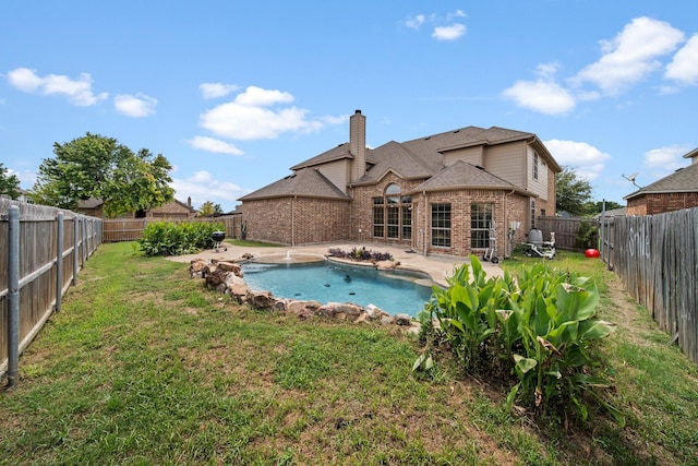 5038 W Fall Dr, Midlothian, TX 76065 - back of property with a patio, a chimney, brick siding, a fenced backyard, and a lawn