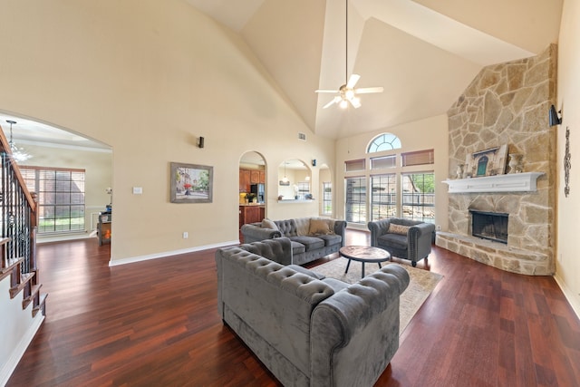 5038 W Fall Dr, Midlothian, TX 76065 - living room with arched walkways, ceiling fan, a fireplace, dark wood-style floors, and stairway