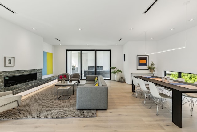 5101 Vickery Blvd, Dallas, TX 75206 - living area featuring a premium fireplace, light wood-style floors, and recessed lighting