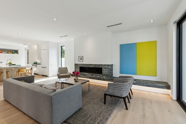 5101 Vickery Blvd, Dallas, TX 75206 - living room featuring light wood-style flooring, a high end fireplace, and recessed lighting