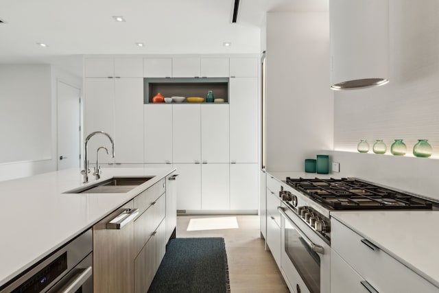 5101 Vickery Blvd, Dallas, TX 75206 - kitchen featuring a sink, high end white range oven, modern cabinets, light wood-style floors, and light countertops
