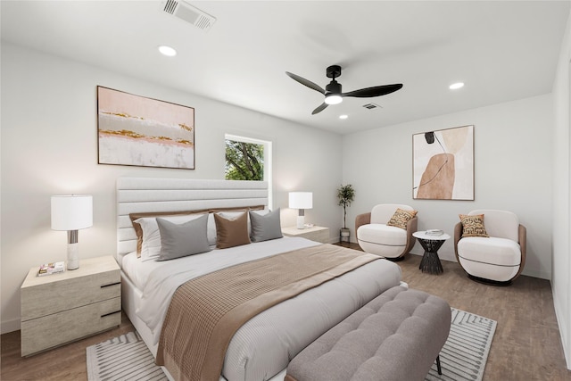 bedroom featuring wood finished floors, visible vents, and recessed lighting