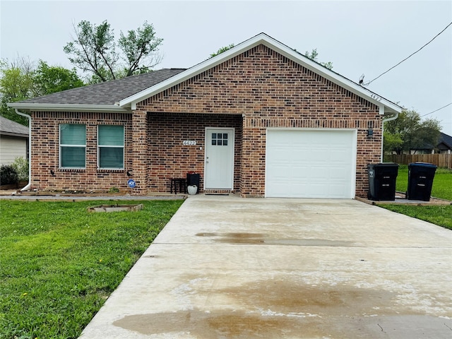 single story home with an attached garage, fence, brick siding, a front lawn, and driveway