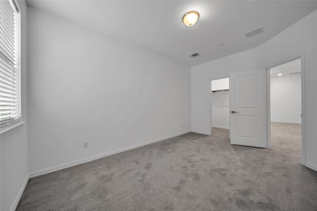 2949 Tenor Way, Sachse, TX 75048 - unfurnished bedroom with carpet flooring, baseboards, a spacious closet, and visible vents