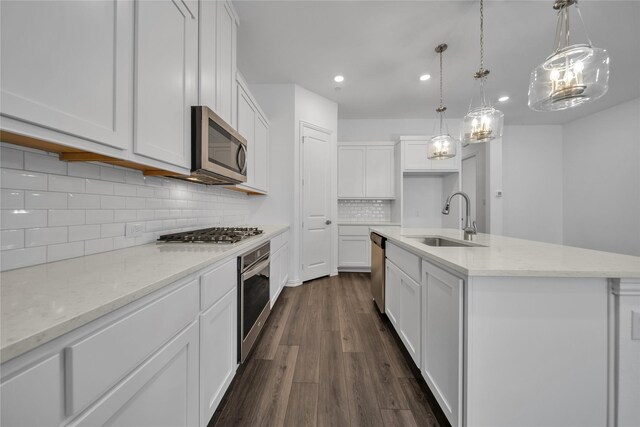2949 Tenor Way, Sachse, TX 75048 - kitchen featuring white cabinets, a sink, appliances with stainless steel finishes, an island with sink, and dark wood-style floors