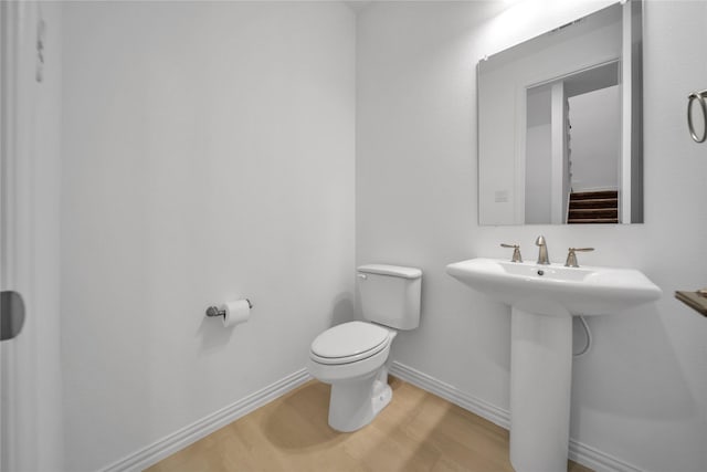 2949 Tenor Way, Sachse, TX 75048 - bathroom with toilet, wood finished floors, and baseboards