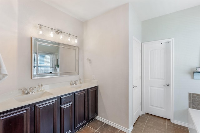 714 Lone Star Ct, Wylie, TX 75098 - bathroom featuring tile patterned flooring, a bathtub, double vanity, and baseboards