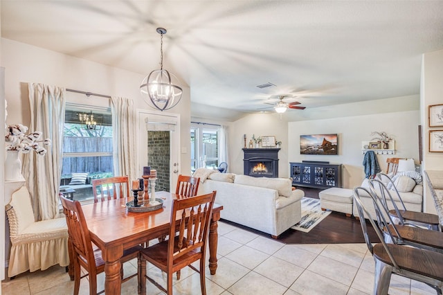 714 Lone Star Ct, Wylie, TX 75098 - dining space with a chandelier, light tile patterned floors, a warm lit fireplace, and ceiling fan