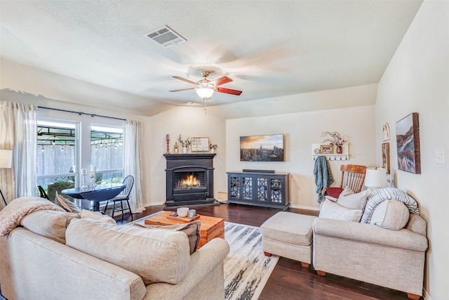 714 Lone Star Ct, Wylie, TX 75098 - living room with dark wood-style floors, a ceiling fan, baseboards, and a warm lit fireplace
