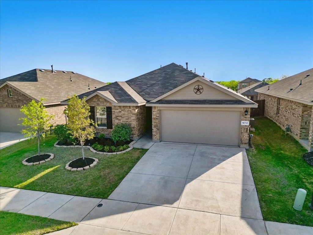 16717 Milwaukee St, Justin, TX 76247 - ranch-style house with concrete driveway, a front yard, brick siding, a garage, and a shingled roof