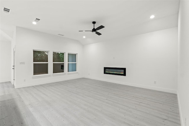unfurnished living room featuring baseboards, vaulted ceiling, a ceiling fan, visible vents, and light wood finished floors