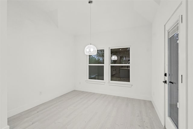 interior space with baseboards, light wood finished floors, and a notable chandelier