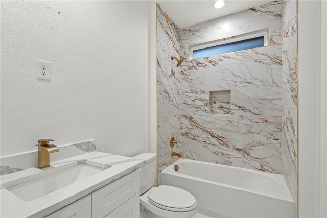 bathroom featuring toilet, shower / bathing tub combination, and vanity