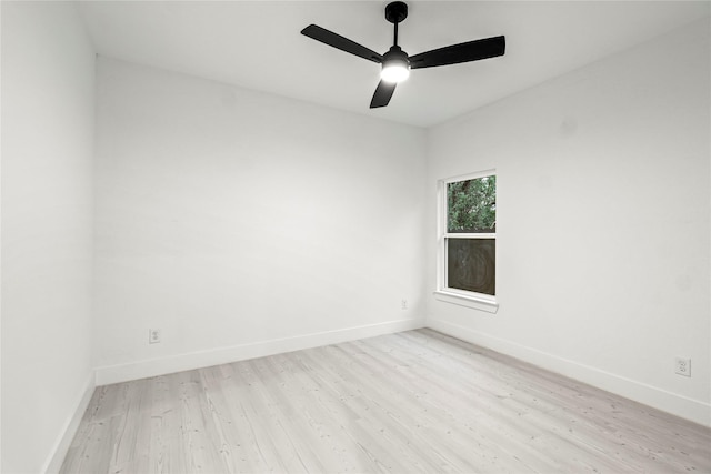 unfurnished room featuring baseboards, light wood-type flooring, and a ceiling fan