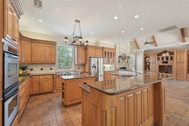 kitchen featuring tasteful backsplash, visible vents, a large island, and stainless steel appliances