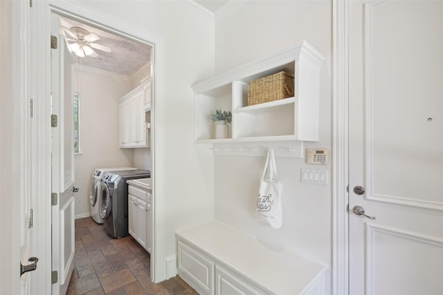 mudroom with crown molding, stone tile flooring, washing machine and clothes dryer, and a ceiling fan