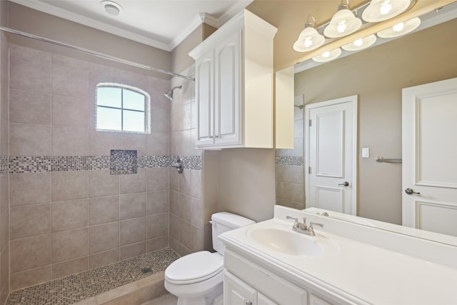 full bath with crown molding, toilet, tiled shower, and vanity