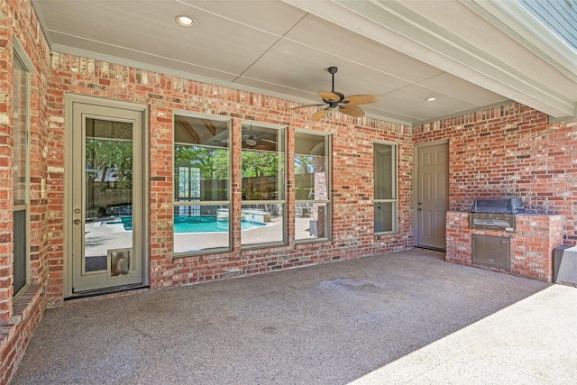 view of patio / terrace featuring grilling area, an outdoor kitchen, and a ceiling fan