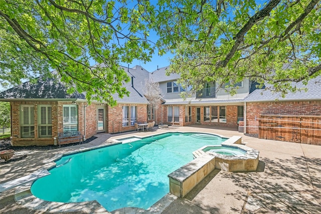 view of pool featuring a patio area and a pool with connected hot tub