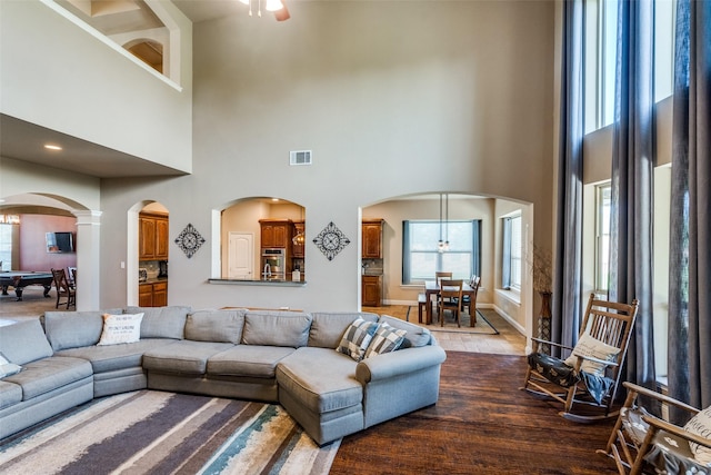 912 Lorene Dr, Wylie, TX 75098 - living area with arched walkways, a towering ceiling, and wood finished floors