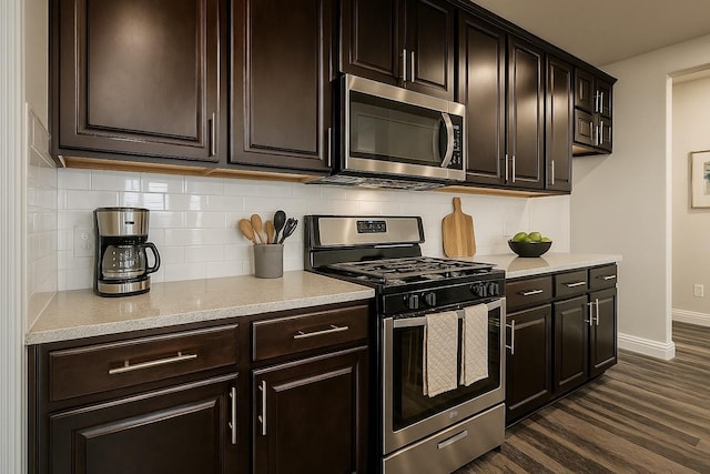 930 Estelle Dr, Euless, TX 76040 - kitchen featuring dark wood-type flooring, baseboards, backsplash, and stainless steel appliances