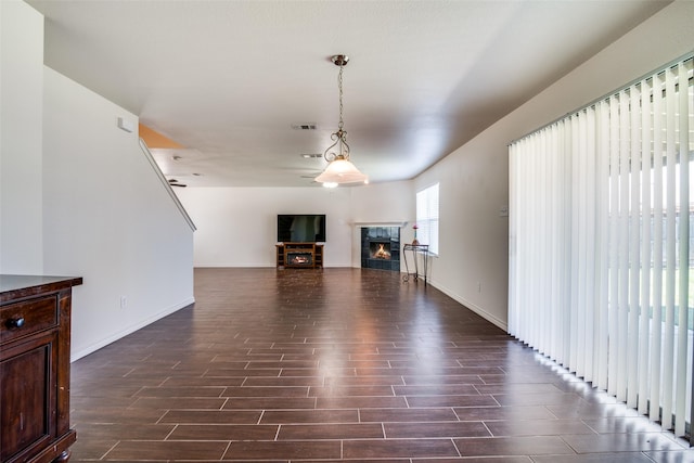 2027 Pine Knot Dr, Heartland, TX 75126 - unfurnished living room with dark wood-style floors, a high end fireplace, and baseboards