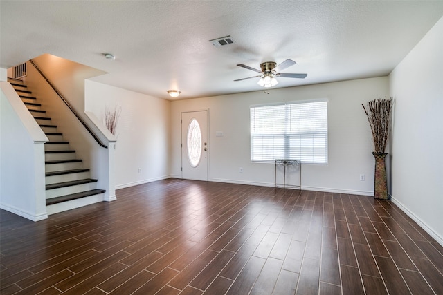 2027 Pine Knot Dr, Heartland, TX 75126 - entrance foyer featuring healthy amount of natural light, a ceiling fan, dark wood finished floors, stairway, and a textured ceiling