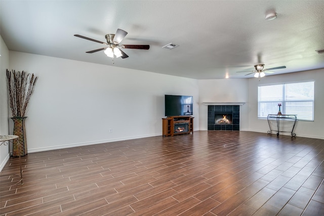 2027 Pine Knot Dr, Heartland, TX 75126 - unfurnished living room with a ceiling fan, a fireplace, dark wood finished floors, and baseboards