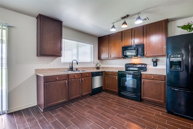 2027 Pine Knot Dr, Heartland, TX 75126 - kitchen featuring black appliances, a sink, light countertops, dark wood-type flooring, and a textured ceiling