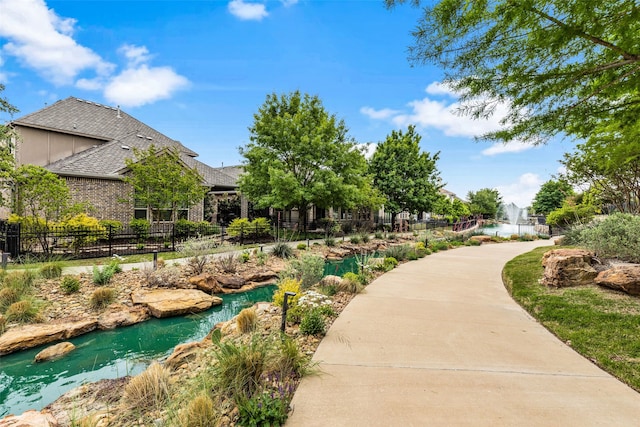 view of property's community featuring fence