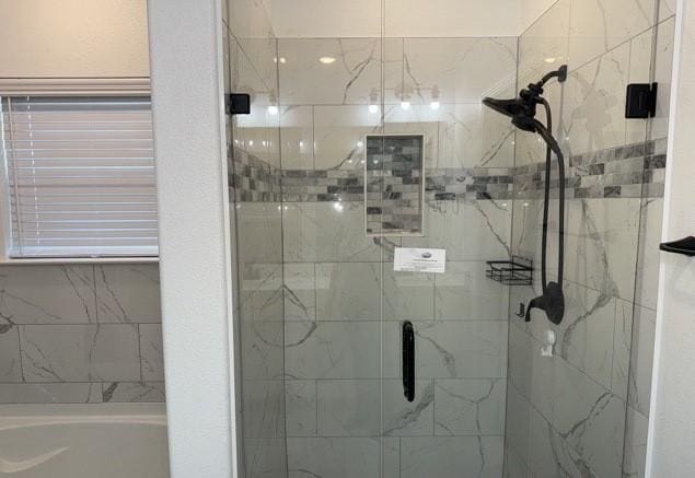 full bathroom with a stall shower and a garden tub