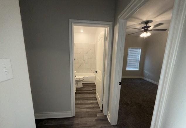 hall with baseboards and dark wood-style floors