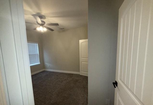 spare room featuring carpet floors, baseboards, and ceiling fan