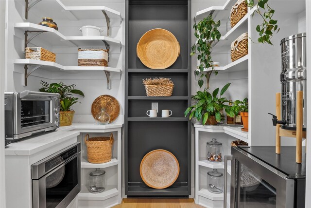 pantry with a toaster and wine cooler
