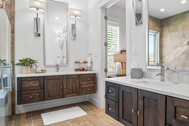 full bath with two vanities, recessed lighting, tile patterned flooring, and a sink