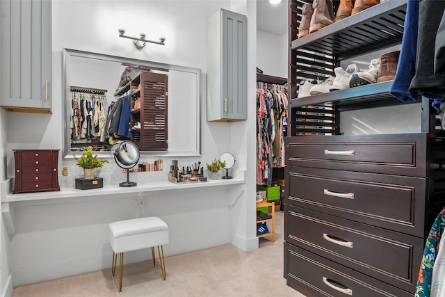 walk in closet featuring light carpet