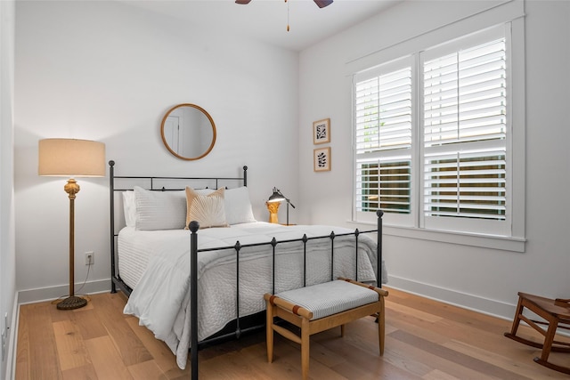 bedroom featuring wood finished floors, ceiling fan, and baseboards