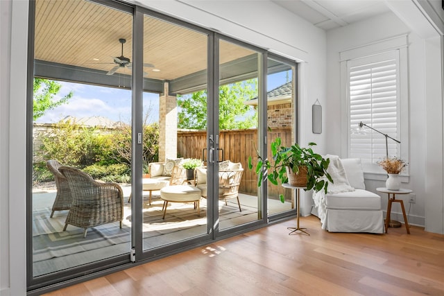 doorway featuring ceiling fan and wood finished floors
