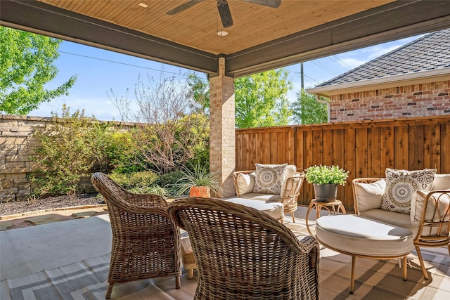 view of patio / terrace with fence and a ceiling fan