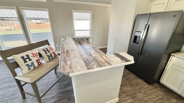 161 Pillsbury Cir, Quitman, TX 75783 - kitchen featuring stainless steel fridge, dark wood-style flooring, ornamental molding, white cabinetry, and light stone counters