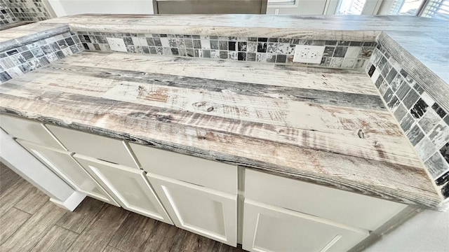 161 Pillsbury Cir, Quitman, TX 75783 - interior details with decorative backsplash, white cabinetry, and dark wood finished floors