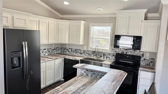 161 Pillsbury Cir, Quitman, TX 75783 - kitchen featuring a sink, backsplash, white cabinets, and black appliances