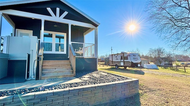 161 Pillsbury Cir, Quitman, TX 75783 - doorway to property with covered porch and a lawn