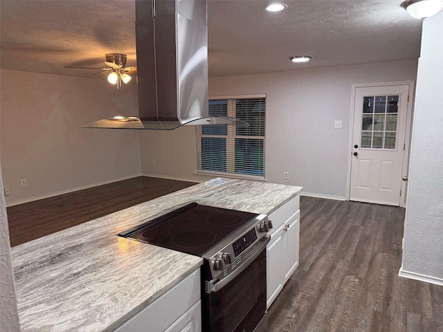 kitchen featuring white cabinets, stainless steel electric stove, island exhaust hood, light countertops, and dark wood finished floors